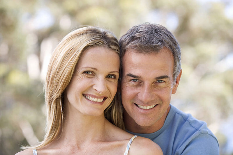 An older couple showing off their smiles.