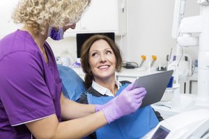 Patient sees her dental x-rays on an iPad.